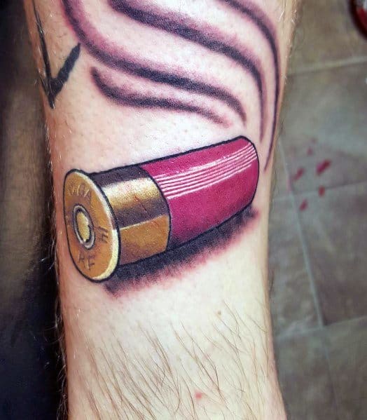 Realistic shotgun shell tattoo with bold red and gold tones, featuring smoky details and shading for a dynamic and striking design.