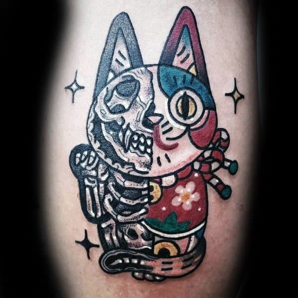 Bold neo-traditional tattoo of a lucky cat with a split skeletal design, vibrant colors, and intricate details for a striking look.