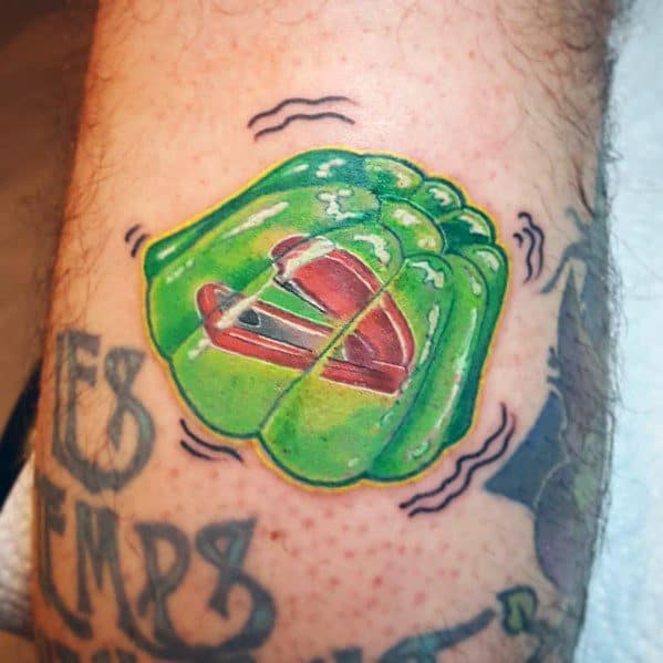 Color tattoo of a red stapler encased in green Jell-O, referencing Jim’s classic prank on Dwight from The Office.