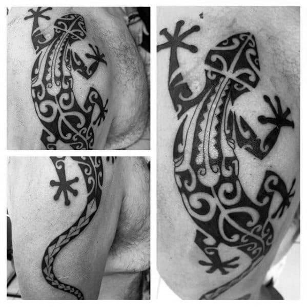 Tribal-style iguana tattoo with bold black patterns and curved lines, featuring intricate symmetry and stylized tail detailing