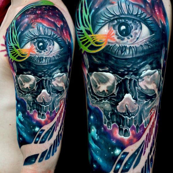 Vibrant inverted tattoo of a cosmic eye above a glowing skull, with neon feathers and a galaxy-inspired background.