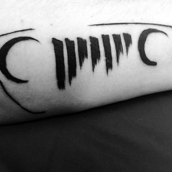 Minimalist black ink tattoo of a stylized Jeep grille with abstract, jagged lines, creating a bold and unique off-road-inspired design.