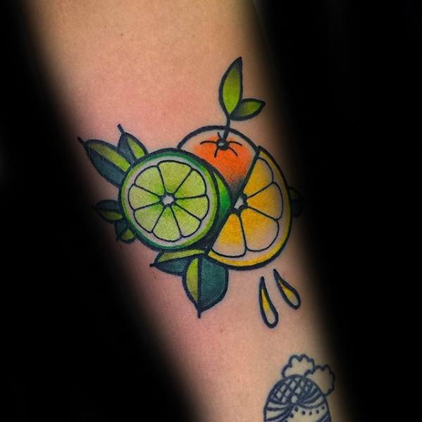 Colorful tattoo of a lime, orange, and lemon slice fused together with leaves and juice drops, outlined in bold black.