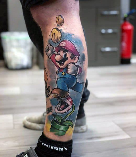 Vibrant *Super Mario* leg tattoo featuring Mario jumping for coins with a Piranha Plant below, blending bold colors and dynamic motion for a classic look.