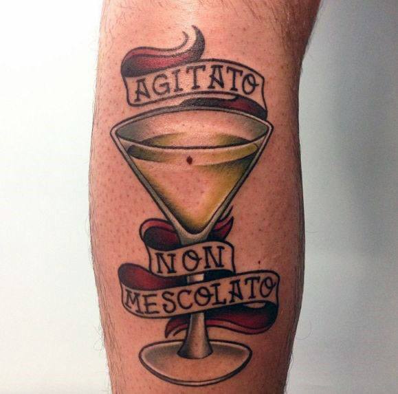 Classic martini glass tattoo with a banner reading "Agitato Non Mescolato" (Shaken, Not Stirred). A bold and stylish vintage design.