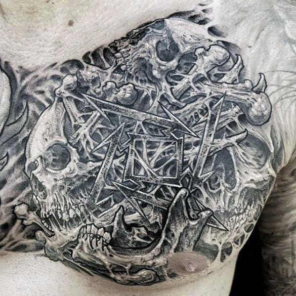 Dark and detailed chest tattoo featuring the Metallica ninja star logo surrounded by skulls and bones in a chaotic, textured black and grey design.