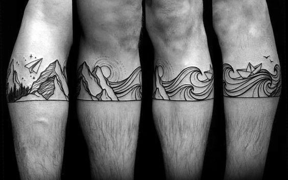 Black ink wraparound tattoo featuring mountains, waves, a paper boat, and a paper airplane, blending fine linework for a continuous adventure-inspired design.