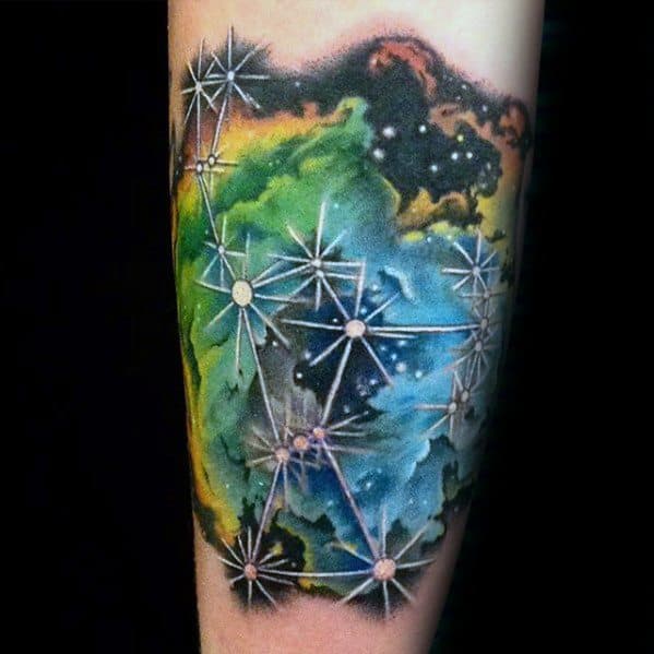 Tattoo of a colorful galaxy and nebula with geometric star patterns on a person's arm