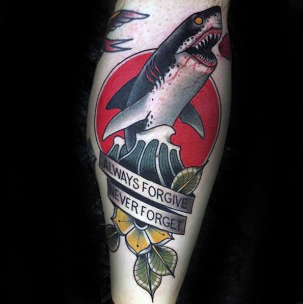 Neo-traditional shark tattoo with a bold red circle, ocean waves, and a banner that reads “Always forgive, never forget.”
