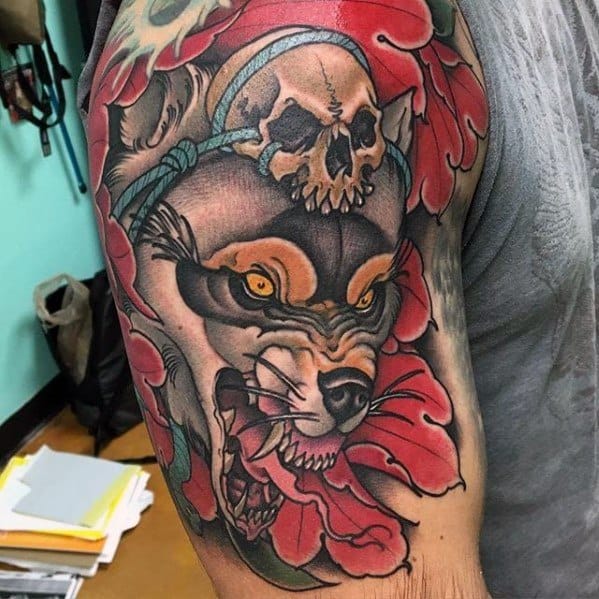 Neo-traditional tattoo of a snarling wolf surrounded by red flowers, a skull above, and bold shading with intricate details.