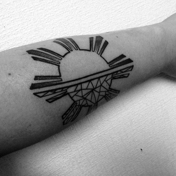 Minimalist Filipino sun tattoo on the forearm with bold linear rays and geometric shading forming a rising half-sun design.