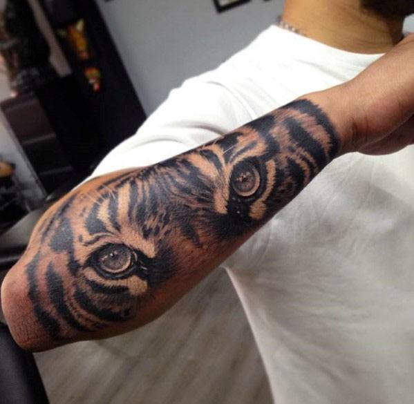 Male Outer Forearm Tiger Eyes Tattoo Design Inspiration