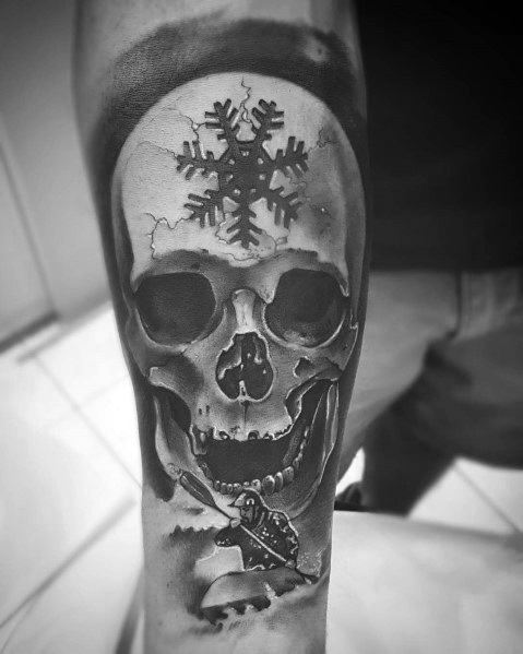 Realistic black and grey skull tattoo with a snowflake on the forehead and a rugged design, symbolizing resilience, strength, and a cold, fearless spirit.