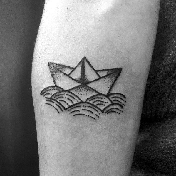 Simple paper boat tattoo floating on stylized waves, symbolizing resilience, exploration, and the journey of life.