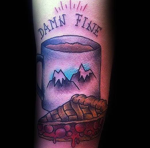 Cherry pie and coffee tattoo with a mountain-themed mug and the phrase “Damn Fine,” inspired by a classic Twin Peaks reference