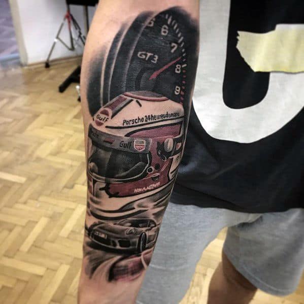 Dynamic Porsche racing tattoo on the forearm, featuring a helmet, speedometer, and racing car details.