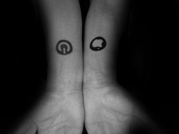 Matching wrist tattoos featuring a black power symbol on one wrist and a cloud icon on the other, both in a minimalist style.