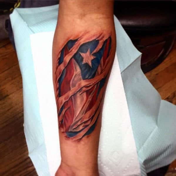 Puerto Rican flag tattoo with a torn skin effect, revealing deep red, white, and blue tones with a bold star underneath.