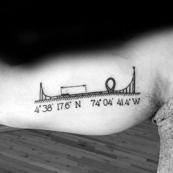 Minimalist roller coaster tattoo with coordinates 4°38′17.6″N 74°04′41.4″W, featuring simple track elements and a loop.