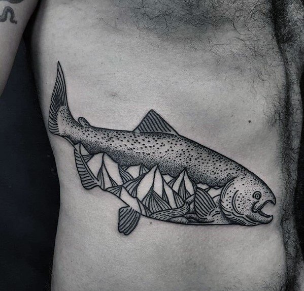 Black and grey dotwork tattoo of a salmon with a mountain landscape inside its body, symbolizing nature and adventure in a detailed rib design.