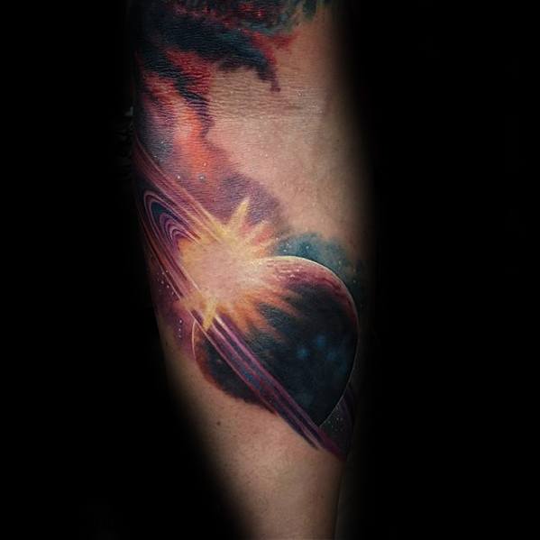 Vivid Saturn tattoo design for men with glowing sunburst, colorful nebula, and detailed planet rings in a cosmic space theme.