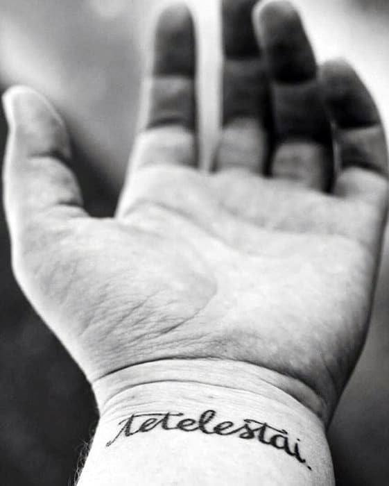 Male Script Tetelestai Wrist Tattoo