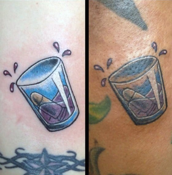 Matching shot glass tattoos with a blue-tinted glass, liquid splashes, and an ice cube inside, designed in a bold and vibrant style.