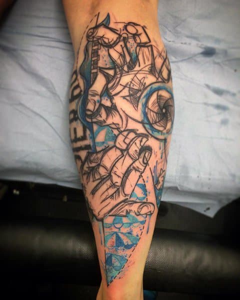 abstract black and blue tattoo featuring hands signing in American Sign Language, combined with geometric shapes and artistic sketch-style elements