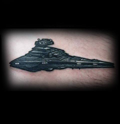 Bold black Star Destroyer tattoo with heavy shading and clean outlines, giving it a sleek and powerful look on the skin.