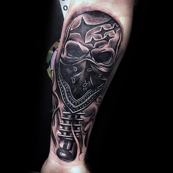 Black and grey Subaru-themed tattoo on the forearm, featuring a skull wearing a bandana with the Subaru stars and a detailed shock absorber.