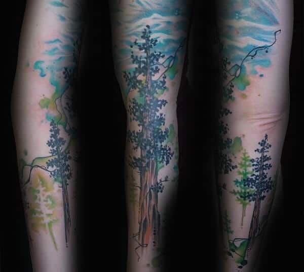 Male Tall Watercolor Tree Tree Tattoo On Forearm