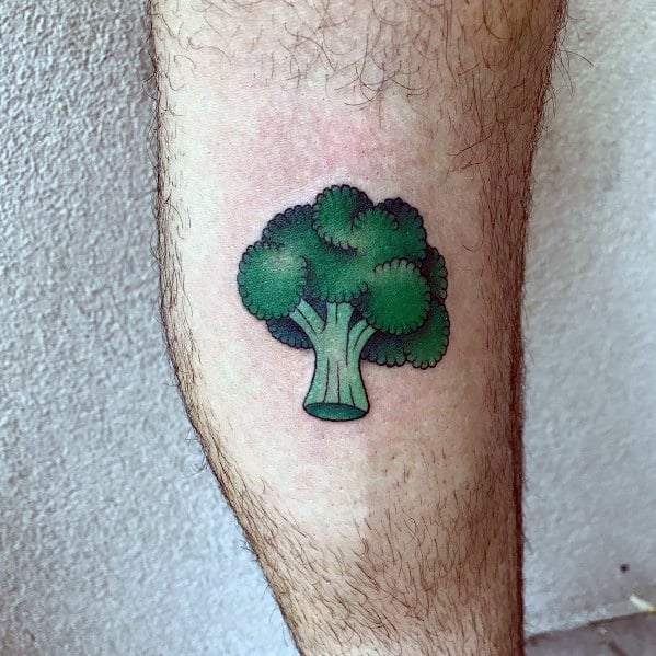 Minimalist broccoli tattoo on the calf, featuring bold outlines and clean shading for a simple yet vibrant design.