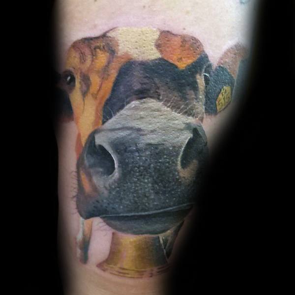 Hyper-realistic cow tattoo with a close-up focus on the nose, featuring lifelike textures, soft shading, and vibrant colors.