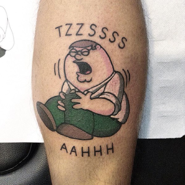 Tattoo of Peter Griffin from Family Guy holding his knee in pain, referencing the iconic "TZZSSSS... AAHHH" scene, with text above and below.