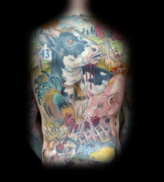 Vivid full-back tattoo featuring a dramatic farm scene with a cow, pig, rooster, and symbolic elements in a bold, surreal style.