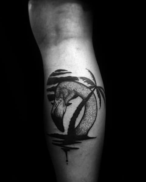 Dotwork flamingo tattoo with a tropical scene, featuring a palm tree, sunset, and water reflection, creating a serene black ink design.