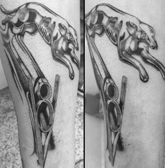 Black and grey Ford V8 logo tattoo with a leaping greyhound, featuring intricate shading and a sleek, dynamic automotive-inspired design.