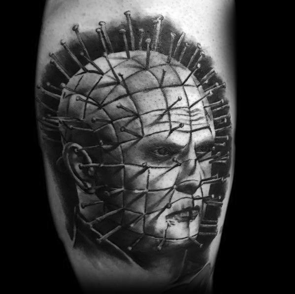 Black and grey *Hellraiser* tattoo of Pinhead with deep shading, precise pin details, and a cold, menacing expression for a haunting effect.