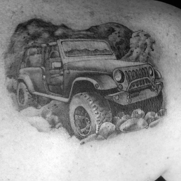 Realistic black and grey tattoo of a rugged Jeep Wrangler with open doors, navigating rocky terrain with detailed shading for a dynamic off-road look.