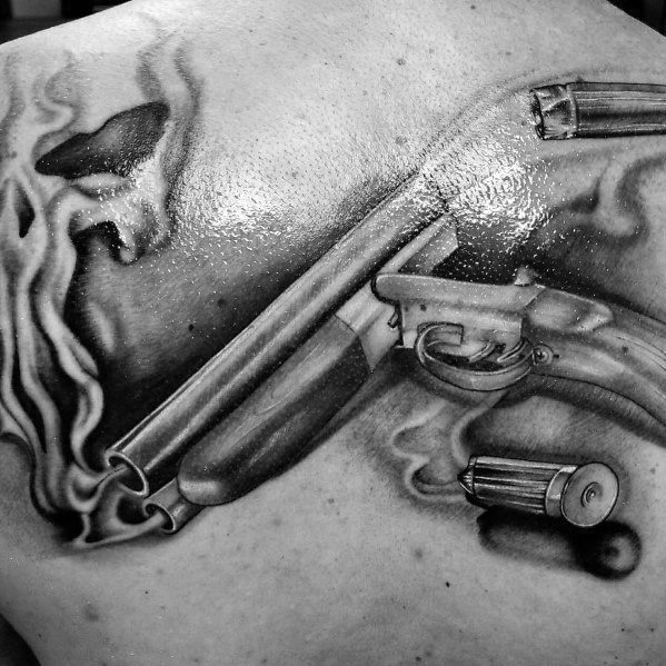 Realistic black and grey tattoo of a smoking double-barrel shotgun with spent shells, featuring detailed shading and dynamic depth.