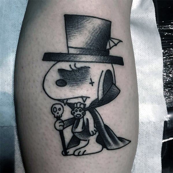 Black and white tattoo of Snoopy dressed as a gothic vampire, wearing a top hat, cape, and fangs, holding a skull-topped cane.