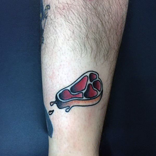 Tattoo of a small, stylized steak with bold black outlines and red shading, featuring a dripping effect for a minimalist yet striking design