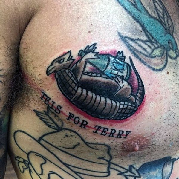 Male Tattoo With Armadillo Bottle Design On Upper Chest