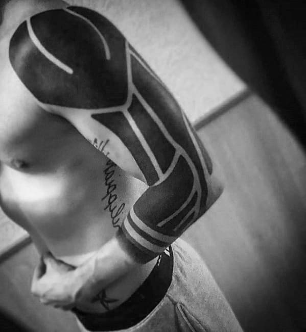 Male Tattoo With Blackout Sleeve Design On Arm