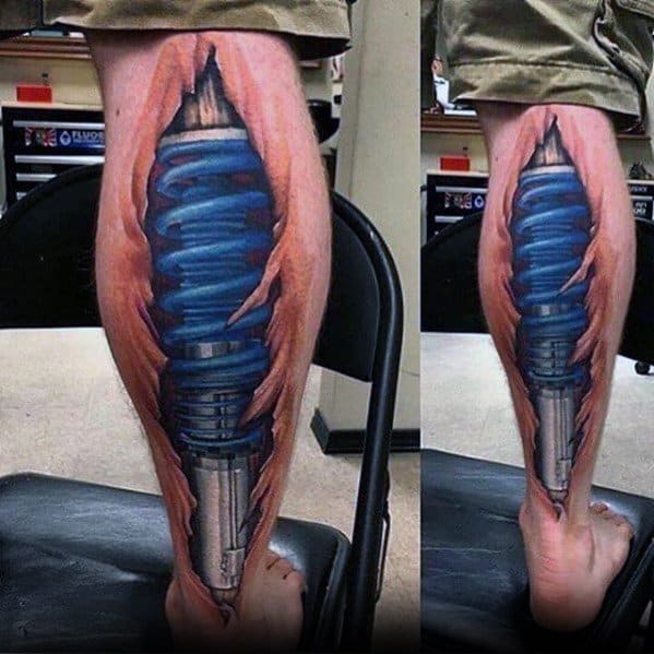 Male Tattoo With Blue Suspension Shock Absorber Design On Back Of Legs
