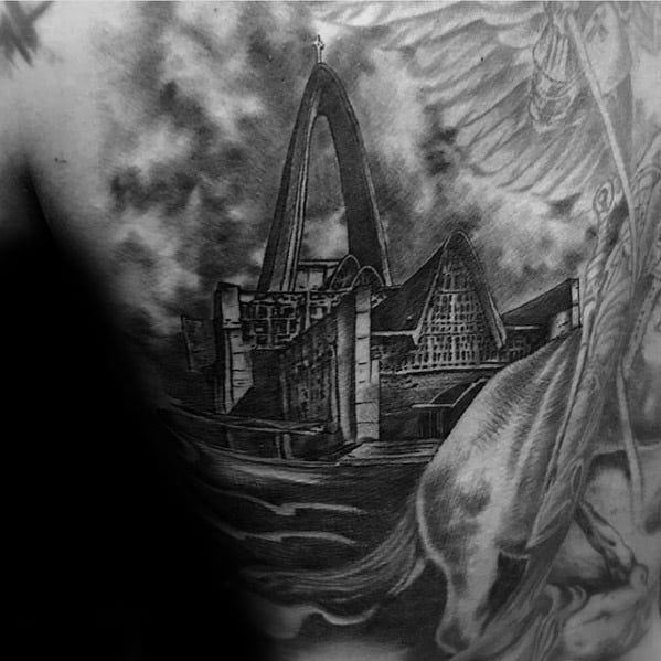 Back tattoo featuring a modern-style cathedral with a large arch and angular rooflines, set against stormy skies and a winged horse.
