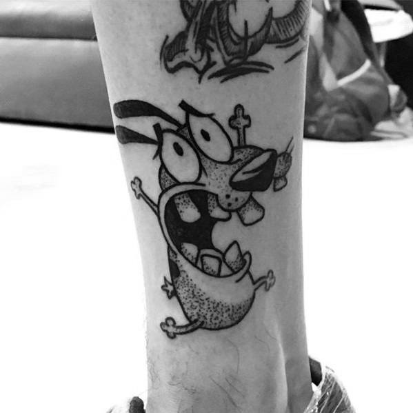 Black and white tattoo of Courage the Cowardly Dog in a classic screaming pose, inked on the side of the lower leg.