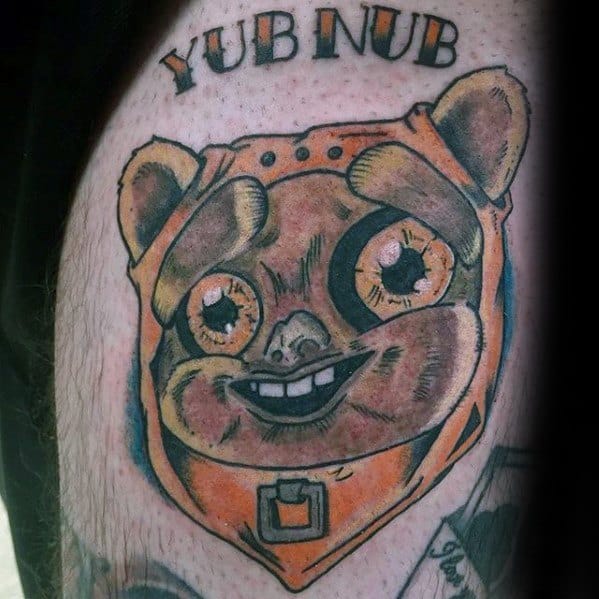 Cartoonish Ewok face tattoo with exaggerated features, bright orange hood, and “YUB NUB” text above in bold lettering.