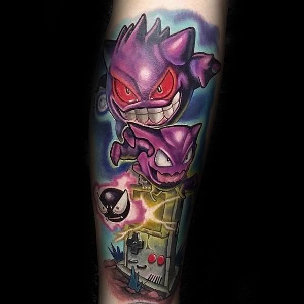 Epic tattoo of Gengar, Haunter, and Gastly emerging from a haunted Game Boy, blending nostalgia with bold, vibrant ghostly energy.