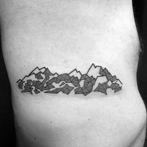 Polygonal mountain range tattoo wrapping around the torso, with abstract geometric shapes and shaded details for a modern look.